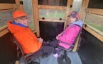 Elly Stortroen, right, 12, of Fergus Falls, Minn., is a fan of blaze pink while deer hunting, while her cousin, Alex Pederson, 15, prefers traditional