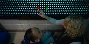 Occupational therapist Cori Smith helps eighth grader Chou Chee Yang work on the light board at North View Middle School in Brooklyn Park, Minn., on N