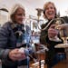 Owner Liz Murphy, right, showed customer Harriette “Cookie” Jandric a silver candle holder at Betty’s Antiques in St. Paul.