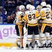 Pittsburgh Penguins goaltender Tristan Jarry is mobbed by teammates after his goal Thursday night.