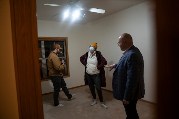 Realtor Josh Nelson, right, showed a two-bedroom townhouse to clients Kane Boxell and Jackie Stillwell on Wednesday in Oakdale.