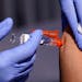 FILE - A patient got a flu vaccine in Lynwood, Calif. 