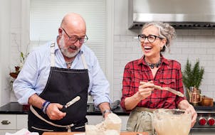 Hosts Zoë François and Andrew Zimmern prepared buche de Noël on their upcoming special “Holiday Party with Andrew & Zoë.”