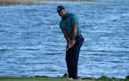 Tiger Woods chips onto the 18th green during the second round of the Hero World Challenge at the Albany Golf Club, in New Providence, Bahamas