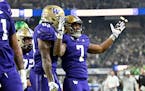 Washington running back Dillon Johnson reacts after scoring a touchdown against Oregon during the first half of the Pac-12 championship 