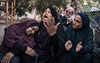 Palestinians mourn their relatives killed in the Israeli bombardment of the Gaza Strip, in the hospital in Khan Younis, Saturday, Dec. 2, 2023. 