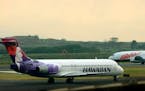An Hawaiian Airlines plane taxied for position at Kahalui, Hawaii, on the island of Maui, March 24, 2005. Alaska Air Group said Sunday, Dec. 3, 2023, 