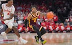 Gophers guard Elijah Hawkins (0) worked his way past Ohio State’s Dale Bonner (4) on Sunday in Columbus, Ohio.