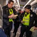 Community service officers Aaron Hardin and Kang Vang checked fares Monday, Dec. 4, on the Green Line in St. Paul. Metro Transit stepped up efforts to