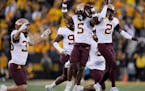 Justin Walley (5) celebrated with fellow cornerback Tre’Von Jones after intercepting a pass during the Gophers’ 12-10 win at Iowa.